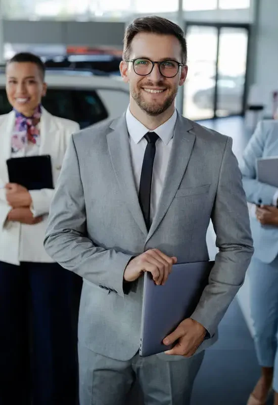 salesteam-in-dealership-three-beautiful-consultants-or-managers-in-elegant-suit-looking-on-camera-